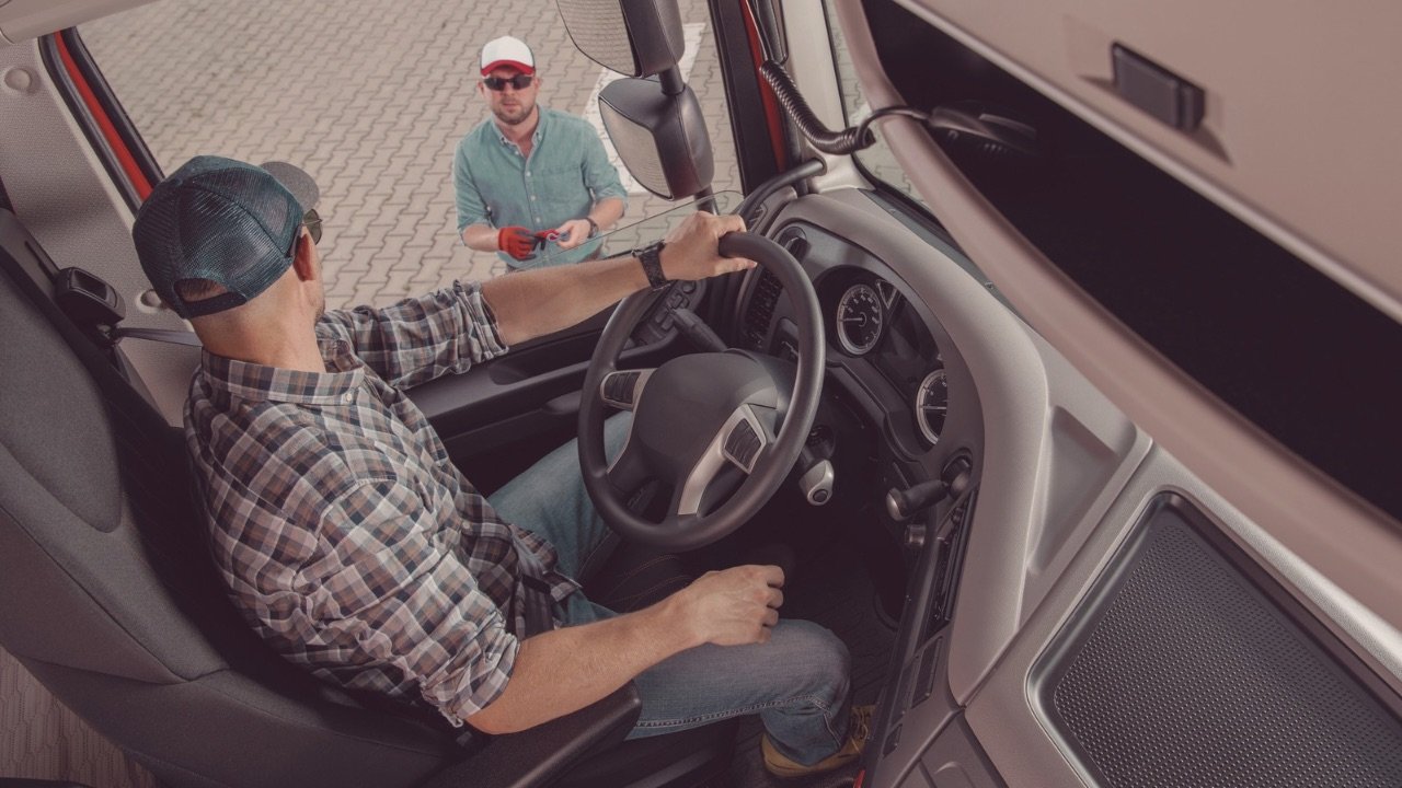 CDL student driver talking with examiner before starting the official CDL test